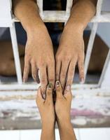 Close-up above, a woman's hand holding a man, accused and held in custody. photo