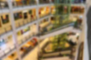 Blurred background of shopping mall center. People shopping in department store. photo
