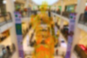Blurred background of shopping mall center. People shopping in department store. photo