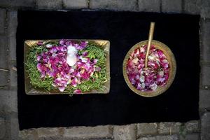 A Bowl of Flower Petals and Leaves for Wedding Ceremony in Wedding Tradition in Indonesia photo