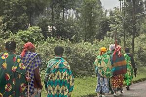 Group of rural Rwandan women in colorful traditionals clothes walking along the road, Kigali, Rwanda photo
