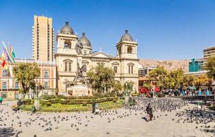 Plaza Murillo, La Paz central square full of pigeons with cathedral in the background, Bolivia photo