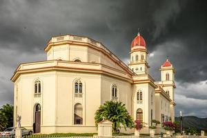 basílica en honor de nuestra señora de la caridad con nubes negras arriba, el cobre, santiago de cuba, cuba foto