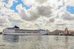Big touristic cruise ship docked in port of Havana with blue sky