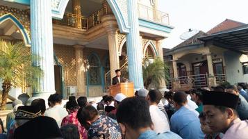 gresik, indonesia, 2022 - you can see people focusing on listening to lectures after carrying out the Eid al-Adha prayers photo