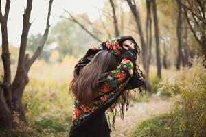 Woman with floral shawl hiding from sunlight scenic photography photo