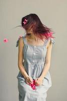 Close up woman shaking head with pink flowers portrait picture photo
