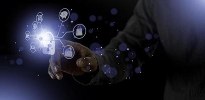 cyber security internet and networking concept. Businessman hand working with VR screen padlock icon on computer background photo