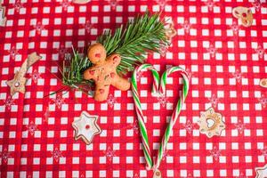 Gingerbread man and sweet candy on bright table photo