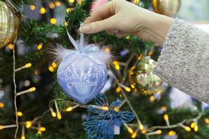 Colorful decorations and balls First Christmas on the branches of fir photo