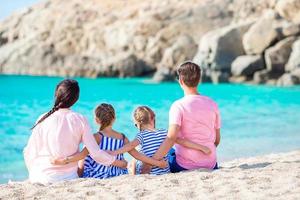 Young beautiful family on beach vacation photo