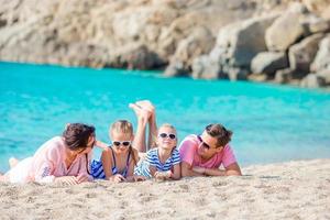 Young beautiful family on beach vacation photo