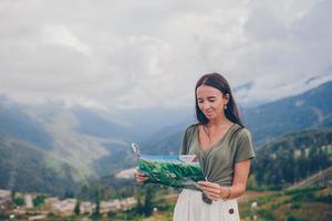 Happy young woman in mountains in the background of fog photo