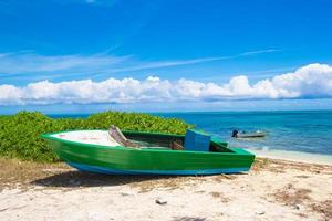 Old fishing boat on a tropical beach at the Caribbean photo