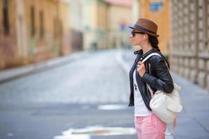 Young caucasian woman listen music in european city outdoors photo