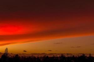 orange red sunset in the evening sky photo