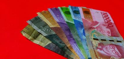 1.000 to 100.000 Indonesian Rupiah. Collection of banknotes Indonesian rupiah isolated on red background. photo
