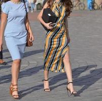 two beautiful girls are walking on the street photo