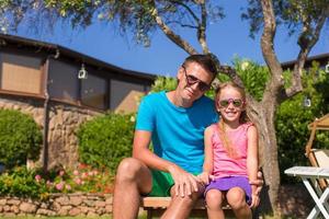 Father and daughter at tropical vacation having fun outdoor photo