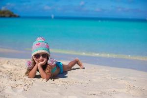 Happy adorable little girl on summer vacation at beach photo