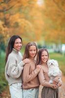 Little girl with mom outdoors in park at autumn day photo