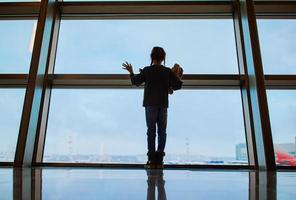 Little kid in airport waiting for boarding photo