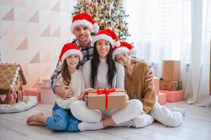 Happy young family with kids holding christmas presents photo