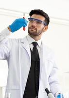 científico masculino que trabaja en el análisis de química en el laboratorio de investigación y desarrollo médico. médico, estudio de experiencia científica y experimento de medicina avanzada en laboratorio de innovación científica de alta tecnología. foto