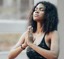 Woman practices yoga namaste position opening soul heart chakra at chest. Female serene people doing meditation in tranquil outdoor, concentrate on prayer pose. Mental wellbeing healthy lifestyle. photo