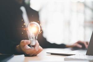 concept with innovation and inspiration, innovative technology in science concept and modern business development,creative idea,Businessman holding a light bulb showing getting new ideas photo