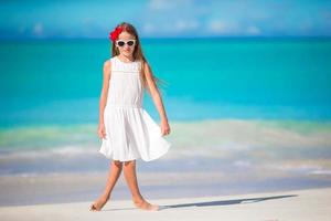 Adorable little kid at beach during summer vacation photo