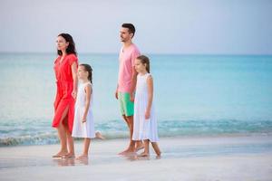 Happy beautiful family on a beach during summer vacation photo