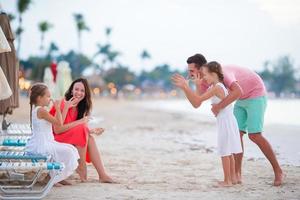 Family on beach vacation having fun photo