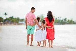 Happy beautiful family on the beach photo