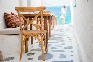 Beautiful typical greek outdoor cafe in Mykonos with amazing sea view on Cyclades islands photo