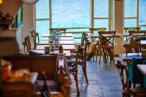 Summer empty openair cafe with beautiful view to the sea in popular area in Mykonos Little Venice photo