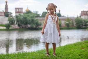 Beautiful shy girl walking outdoor near the lake photo