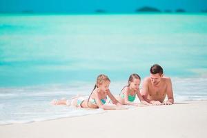 Father and little kids enjoying beach summer tropical vacation. Family playing on the beach photo