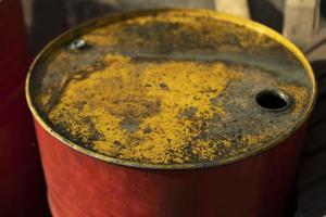 Fuel barrel with yellow lid. Red fuel tank. Old canister. photo