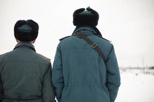 Two rescue workers. Men in uniform. Warm lifeguard uniform in Russia. photo