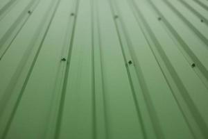 Green steel wall. Details of cladding of building. photo