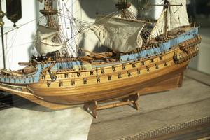 Small ship. Model of frigate. Sails on wooden ship. photo