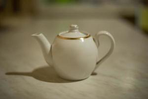 Kettle on table. Teapot in kitchen. photo