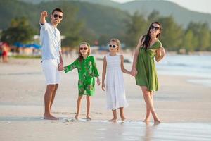 Young family on vacation on tropical beach photo