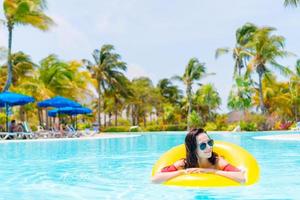 Beautiful young woman relaxing in swimming pool. photo