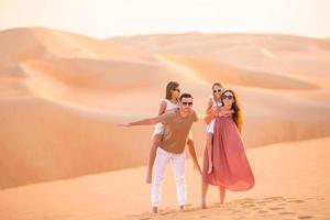 People among dunes in Rub al-Khali desert in United Arab Emirates photo
