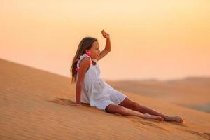 Girl among dunes in Rub al-Khali desert in United Arab Emirates photo