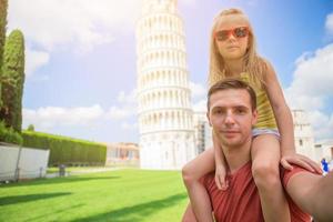 Family portrait background the Learning Tower in Pisa. Pisa - travel to famous places in Europe. photo
