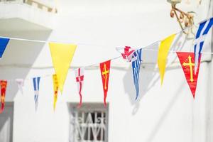 Street with colorful flags in Mykonos, Greece photo