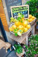 Wicker basket full of lemons on the italian street od Corniglia photo